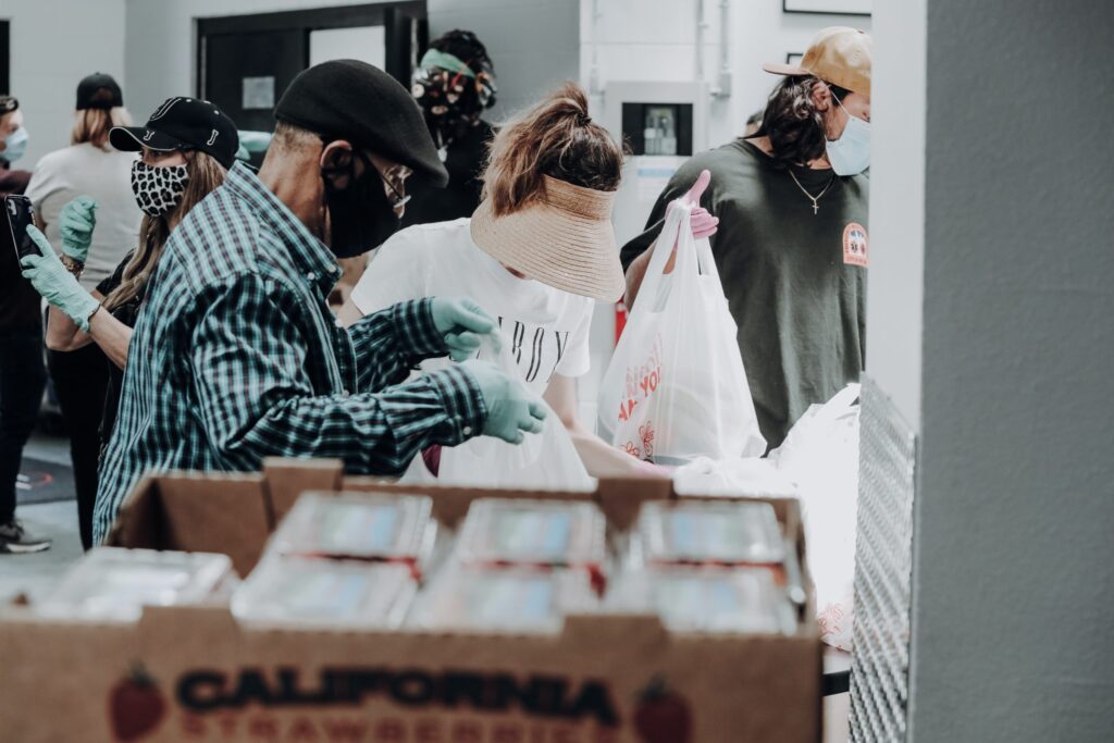 Volunteers bag food at a community food bank event