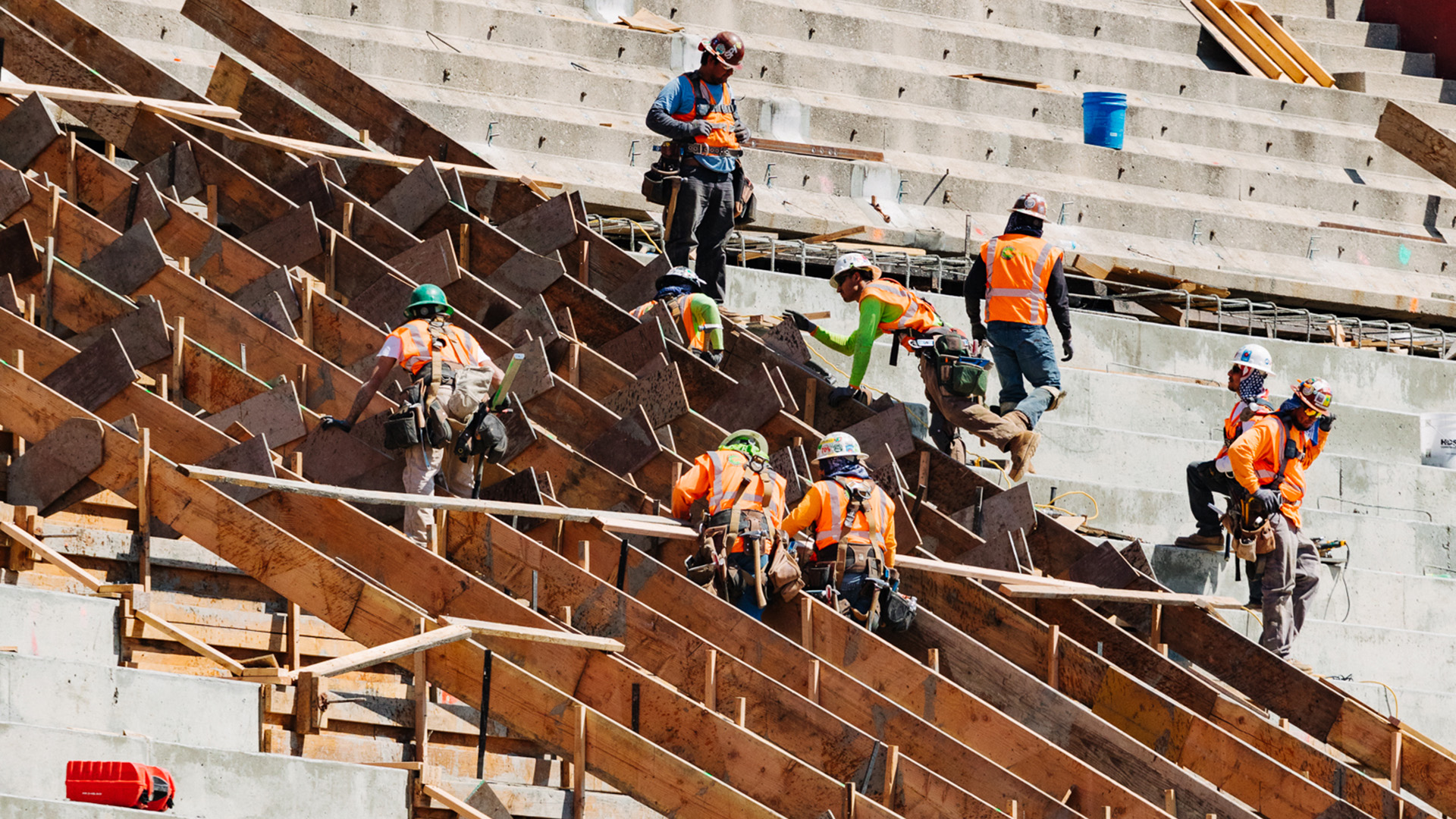 Group of construction workers building in a stadium