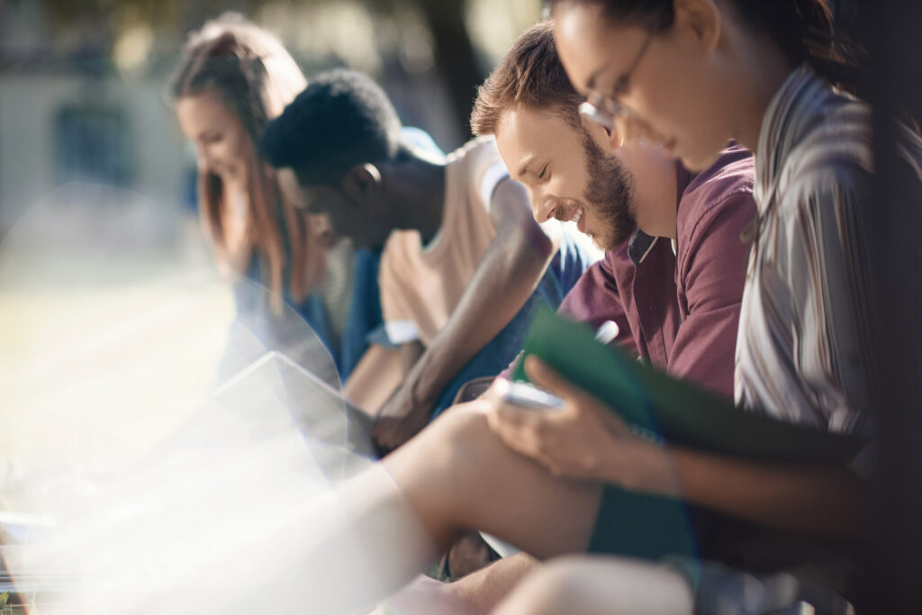 Group of community college students studies together outside